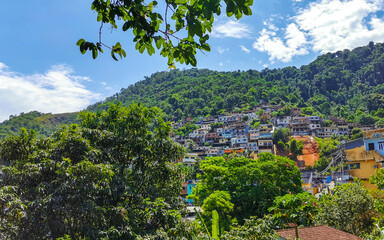 Mountains with favelas houses tropical nature Angra dos Reis Brazil.