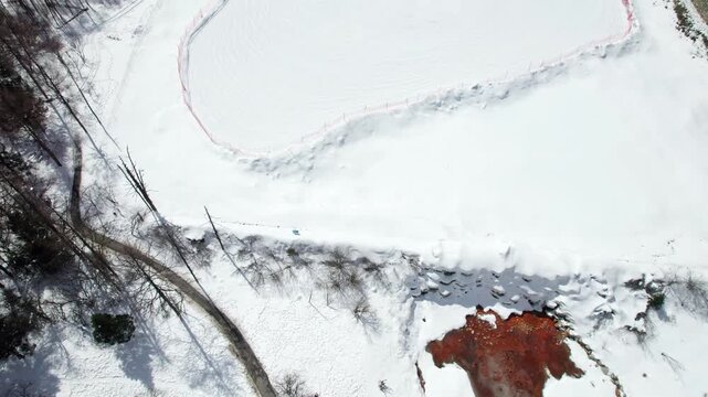 Drone view of snow covered mountains and forests in Bipeng Valley in Sichuan, China in sunny winter day, high angle view of beautiful winter landscape. 4k real time footage, travel concept.