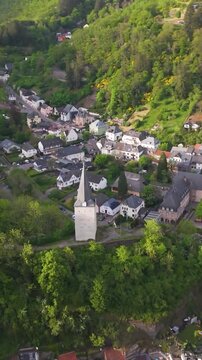 vianden town beautiful old homes green hills flowing river roads traffic luxembourg to left right circles drone circling view 