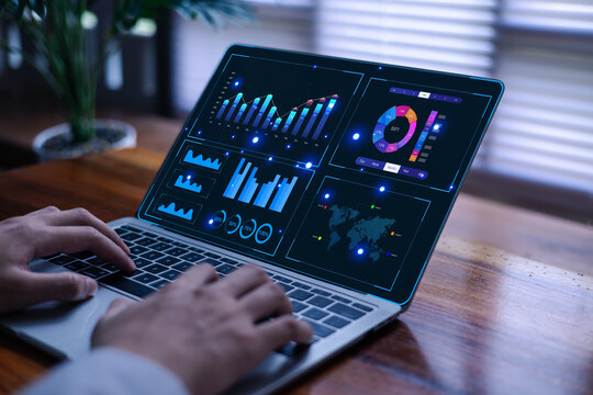 Business analytics dashboard on a laptop screen showing charts, graphs, and performance data as a user works, reflecting digital analysis, data insights, financial metrics, and modern technology.