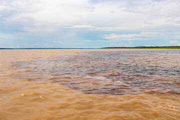 Meeting of waters Rio Negro and Amazon River Amazonas Brazil.
