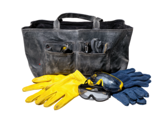 Toolbag with yellow gloves and safety glasses on dark bg