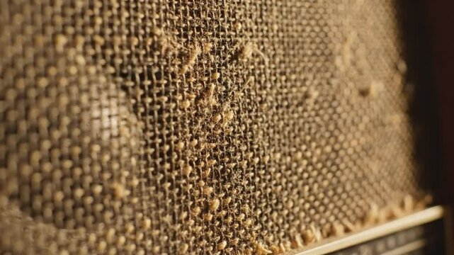 Macro View of Vintage Woven Fabric Speaker Grille - Retro Audio Texture Background