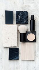 A collection of cosmetic items and textured materials are arranged in a flat lay composition on a white, textured surface.