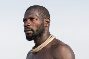 weary man with hoop around his neck sits in despair reflecting deep emotional fatigue
