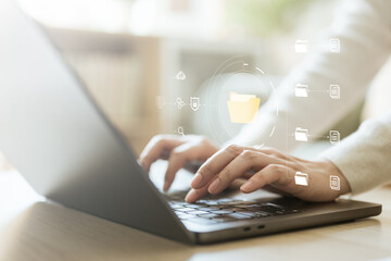 Hands typing on laptop with floating digital folders and workflow icons, representing document management, compliance workflow, approval processes, and secure file handling.