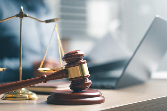 law, legal, justice, court, attorney, A wooden gavel and justice scale placed on a desk with a laptop in the background, symbolizing law, legal decisions, court judgement, and attorney services.