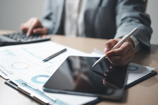 tablet, analysis, data, report, A person working with a tablet and stylus alongside financial documents and charts, representing data analysis, report review, planning, and business management tasks. - Powered by Adobe