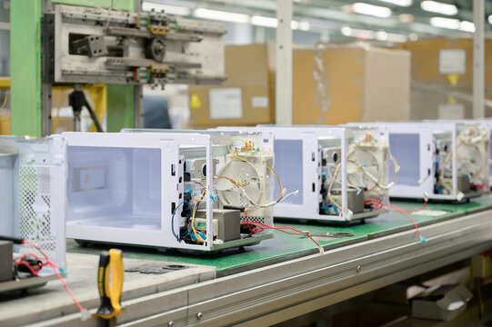 Assembly workshop focusing on microwave oven production in a manufacturing plant