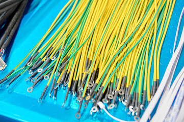 Colorful electrical wires organized neatly on a blue table ready for use in various projects and applications