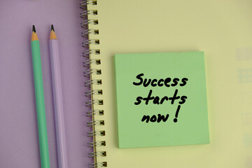 Success starts now written on notepad on clean desk