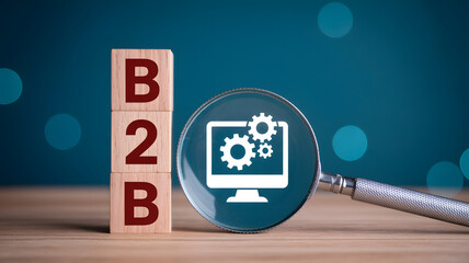 Business to business concept with B2B blocks and magnifying glass over tech gear icon