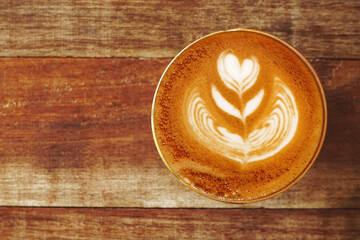 a cup of latte art coffee on wooden background                                       