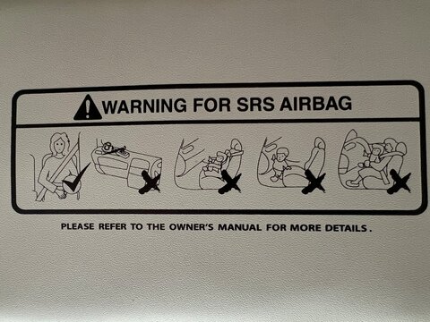 This decal provides safety instructions for the Supplemental Restraint System (SRS) Airbag. It uses pictograms to illustrate acceptable and prohibited actions within the vehicle.