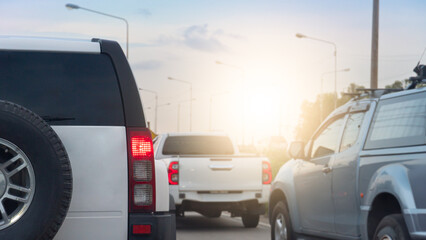 Rear side family car white color SUV model. Many cars driving on the road with sunlight on the sky.