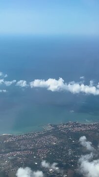 quaint town lies below easyjet plane flies lake distant sea under cloudy sky varied landscapes above en route rome to from aerial view air travel scenic flight aircraft 