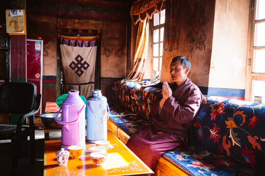 Monk inside monastery kitchen, Tibet