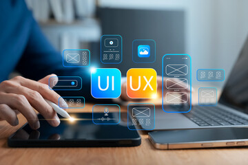 UI/UX design concept showing wireframe interface development on tablet using stylus. Ideal for...