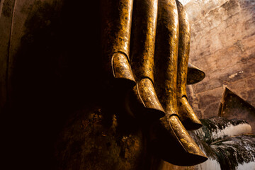 Monumental Buddha image Phra Atchana in subduing mara posture at Wat Sri Chum temple Sukhothai Historical Park, ancient stuccoed brick sculpture, thailand cultural heritage landmark