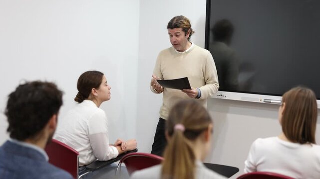 Knowledgeable professor explaining subject to classroom full of students