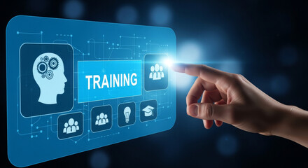 An index finger presses a training button on a blue digital interface display, showcasing technology, learning, and business training elements. The screen includes icons and futuristic design.