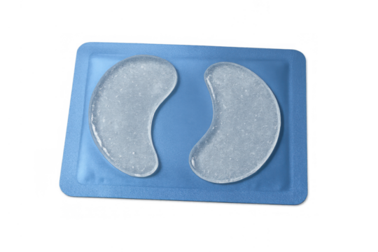 Under-eye hydrogel patches in blue packaging for skincare and beauty treatment, transparent background