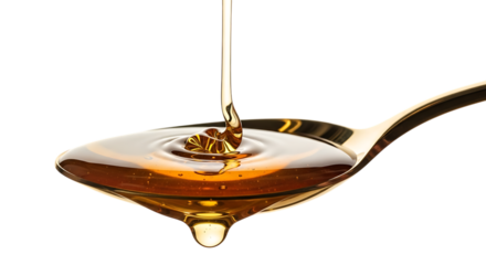 Golden honey pouring onto a spoon isolated on transparent background
