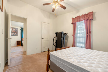 A pleasing bedroom with a comfy bed and a ceiling fan