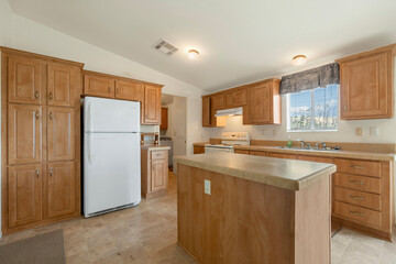 A beautiful kitchen with wooden cabinets and a white refrigerator
