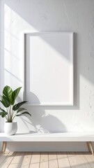 Vertical white frame mockup on a white wall with a plant on a bench and sunlight shadows.
