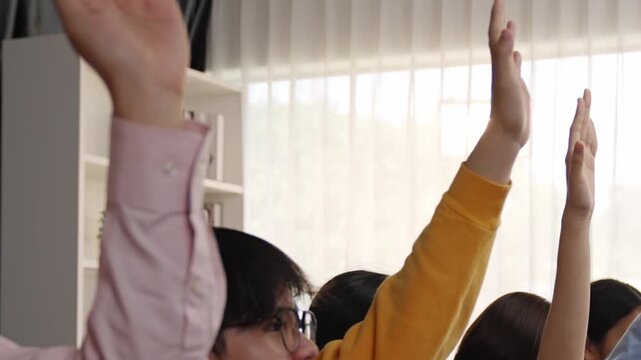 Group of interviewee candidate in colorful casual wearing line up for vacancy interview sitting on the chair. Intern raise hand. Job opportunity recruitment for HR agency and vacancy concept. Synergic - Powered by Adobe