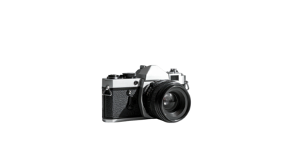 Old film camera with textured grip on stark black background