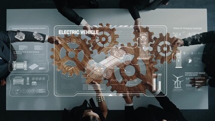 A group of professionals collaborates around a modern conference table featuring digital interfaces, gears, and electric vehicle concepts, illustrating teamwork and innovation in technology. Raster - Powered by Adobe