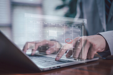 Digital calendar on laptop screen with highlighted dates, symbolizing schedule planning, time...