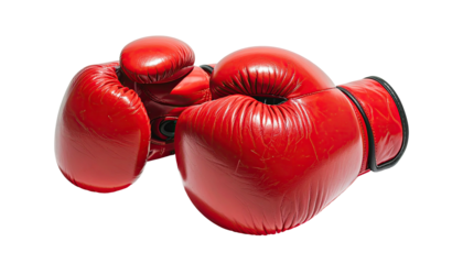 Two bright red boxing gloves rest against a black backdrop