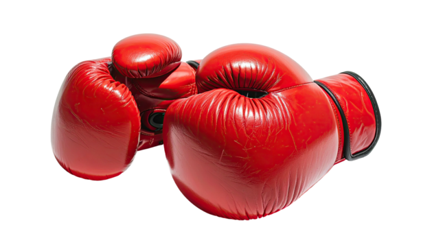Two bright red boxing gloves rest against a black backdrop