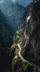 Winding Road Carved into Steep Mountain Cliffside, Dramatic Lighting.
