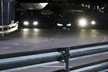 Exciting race car on dark circuit at night. motorsport event shows high speed action on asphalt track with bright headlights illuminating intense competition
