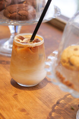Cold coffee served with a sweet treat on a wooden table