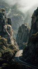 Dramatic Mountain Pass Road Winding Through Rugged Peaks Under Ethereal Misty Sunlight.