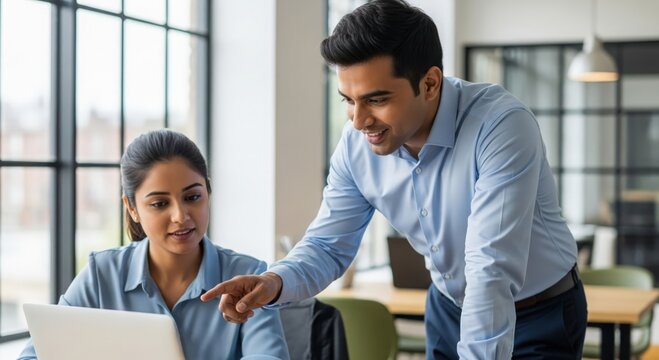 Indian HR Manager Assisting Team Member — Modern office interaction and employee support