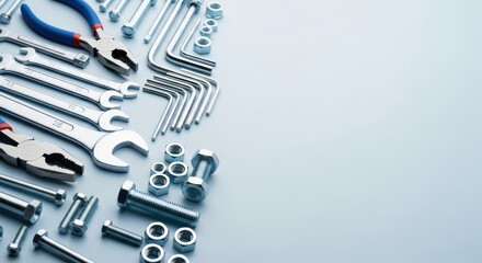 Arrangement of wrenches allen keys nuts and bolts hardware tools isolated on a light blue background showcasing mechanical equipment