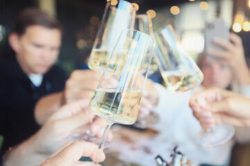 Friends with glasses of wine clink glasses holiday, a group of people abstract blurred background