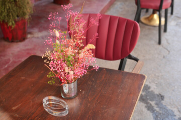 Bright floral arrangement on a cafe table in the afternoon