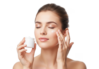 Young woman applying moisturizing cream to her face with eyes closed in a serene beauty ritual isolated on transparent background