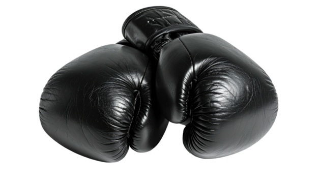 Pair of black boxing gloves stacked, isolated on dark backdrop
