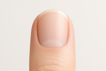 Close up view of human fingernail showcases its smooth surface and natural shine, emphasizing importance of nail care in medical and personal grooming routines