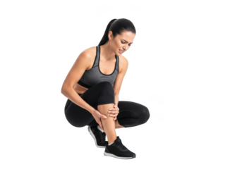 Athletic woman experiencing leg pain while crouching down in a fitness pose isolated on transparent background