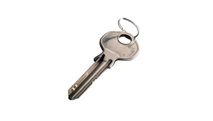 Single metal key angled against a dark, out-of-focus ground