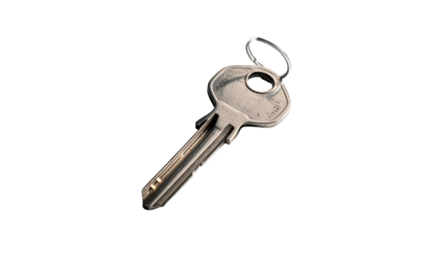 Single metal key angled against a dark, out-of-focus ground